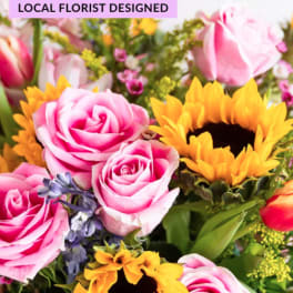 Bouquet of pink roses and yellow sunflowers with mixed blooms