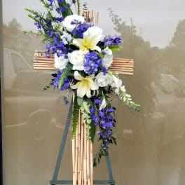 Blue and white floral cross on a bamboo stand
