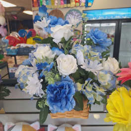 Basket arrangement of blue and white artificial flowers