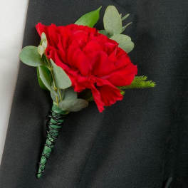 Red carnation boutonniere with eucalyptus on a black suit lapel
