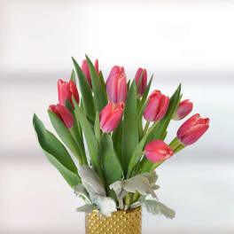 Pink tulips arranged in a gold dotted vase