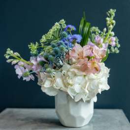 Pastel mixed bouquet in a white vase with white hydrangeas and pink alstroemeria