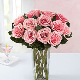 Pink roses arranged in a clear glass vase