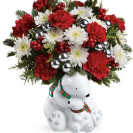 Red and white floral arrangement in a teddy bear container