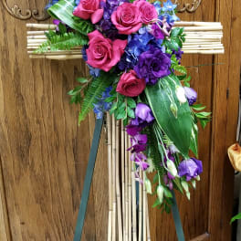 Purple and pink floral spray on a bamboo cross easel