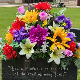 Colorful floral arrangement on a gravestone in a cemetery