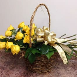 Basket of yellow roses with a gold ribbon bow