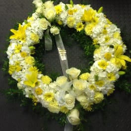 Yellow and white floral wreath with roses and lilies