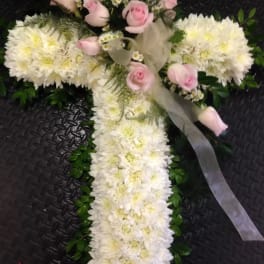 White floral cross with pink roses and ribbon