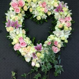 Heart-shaped floral wreath with pink roses and white lilies