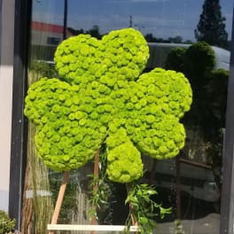 Bright green floral arrangement shaped like a four-leaf clover