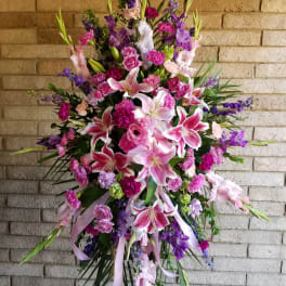 Large standing spray of pink and purple lilies and carnations