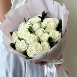 Bouquet of white roses wrapped in pale pink paper