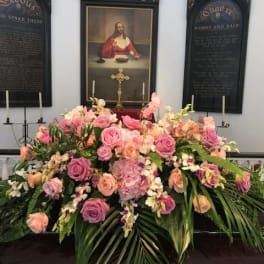 Large pink and peach floral casket spray with roses and orchids