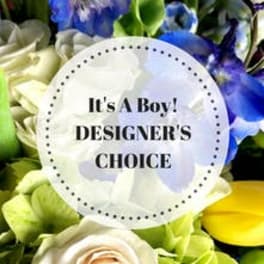 Mixed bouquet with blue, white, and green flowers and a baby boy card