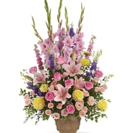 Tall pink and purple floral arrangement in a decorative vase