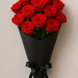 Bouquet of red roses wrapped in black paper with a black ribbon