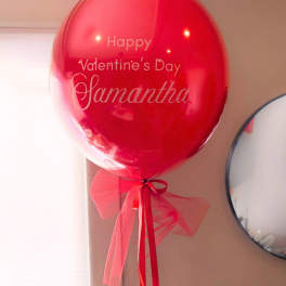 Red Valentine’s Day balloon with a ribbon bow