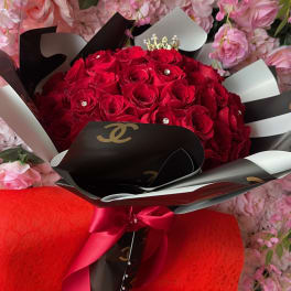 Bouquet of red roses wrapped in black and white paper with a red ribbon