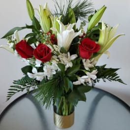 Bouquet of red roses and white lilies in a gold vase