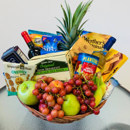 Gift basket with fruit, snacks, tea, and two bottles of wine