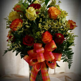 Two dozen mixed color roses arranged in a vase