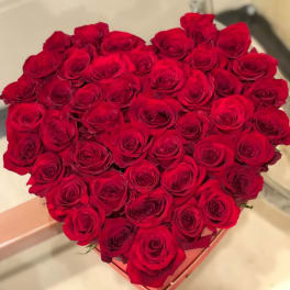 Heart-shaped box filled with red roses
