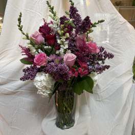 Pink and purple mixed bouquet in a clear glass vase