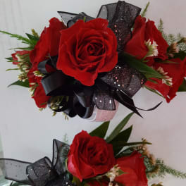 Two red rose bouquets with black ribbon bows
