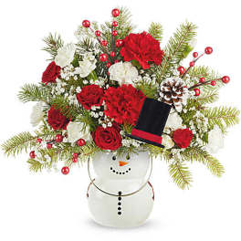 Holiday bouquet in a snowman vase with red and white flowers