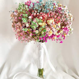 Colorful bouquet of tiny clustered flowers tied with a white ribbon