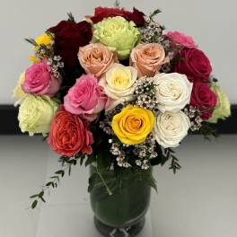 Mixed rose bouquet in a dark glass vase