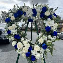 Blue and white floral wreath on a stand