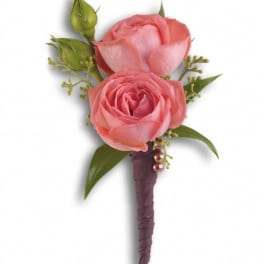 Pink rose boutonniere with green buds and leaves