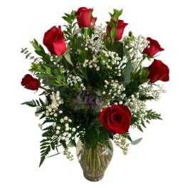 Red roses and white baby's breath in a clear glass vase
