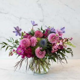 Pink and purple mixed bouquet in a clear glass vase