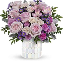 Pink roses and purple daisies in a mosaic vase