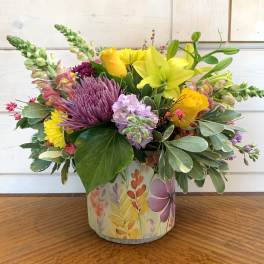 Colorful mixed bouquet in a painted cylindrical container