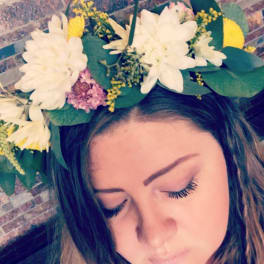 Woman wearing a white and yellow flower crown