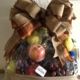 Fruit basket with a large bow and assorted fruit in clear wrap