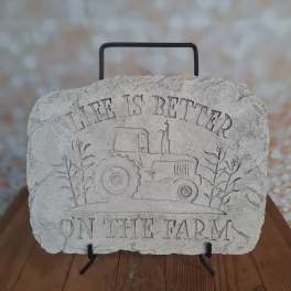 Decorative stone plaque with a tractor and the words "Life is Better on the Farm"