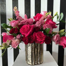 Pink and red rose bouquet in a metallic vase