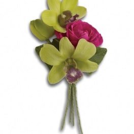 Boutonniere with green orchids and a pink rose