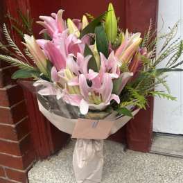 Bouquet of pink lilies wrapped in paper