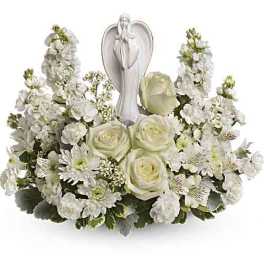 White floral arrangement with an angel figurine in the center