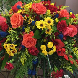 Large mixed bouquet with roses, daisies, and carnations in red, yellow, and orange