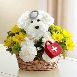 White teddy bear floral arrangement in a wicker basket with yellow flowers
