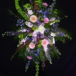 Large standing floral spray with pink, purple, and white flowers