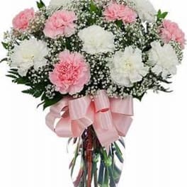Pink and white carnation bouquet with a pink ribbon in a vase
