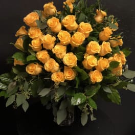 Bouquet of yellow roses in a glass vase
